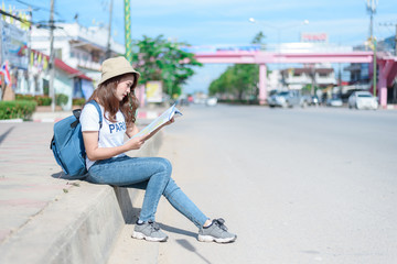 Fototapeta premium A woman is looking at a map for traveling,traveling in Thailand,traveling in Chiang mai 