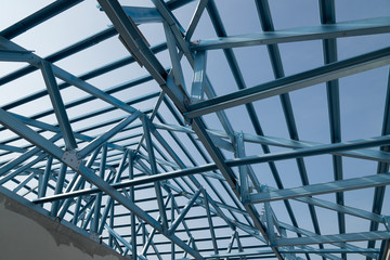 Fototapeta premium Structure of steel roof frame for building construction.