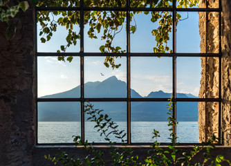 lake and mountain view in Torri del benaco through an ancient window