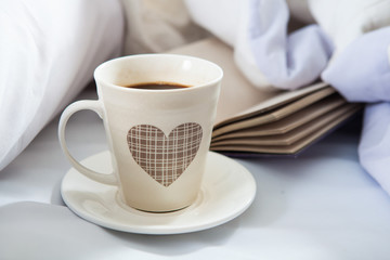 Bedroom on the bed, morning coffee. Happiness. A heart.