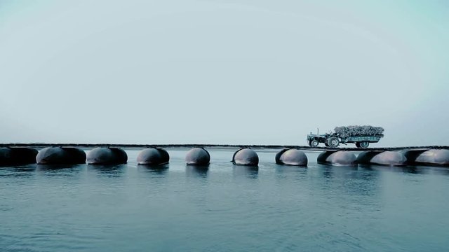 Videos of a temporary pontoon bridge made with used gas containers over river Ganga near Makhdoompur village in Hastinapur Wildlife Sanctuary at Meerut
