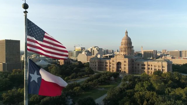 4K Texas Capital with Texas Flag and American Flag Aerial Slow Motion