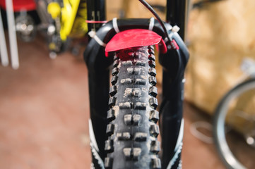 Fototapeta na wymiar Mountain bike tire tread closeup at home workshop