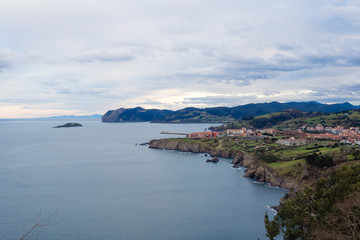 View of the coast of the village of Bermeo on a cloudy day, in the Basque Country