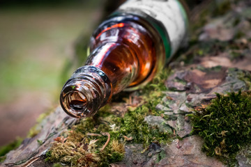 Small bottle with red stain dripping from its mouth