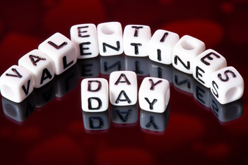 Word valentines day from cubes on a dark background.