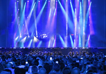 wide stage in the stadium with many people at live concert