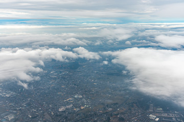 Blue sky background, viewed from an airplane window.