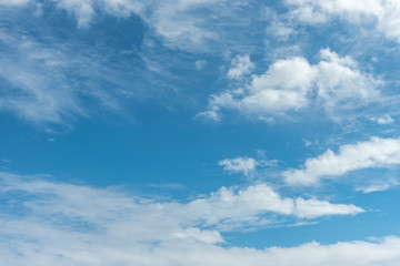Blue sky background, viewed from an airplane window.