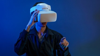 Young guy in a black shirt and white glasses of virtual reality