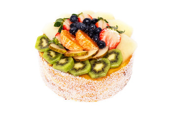 Delicious mixed fruits cake on white isolated background .
