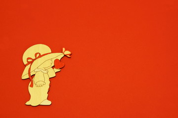 Vintage stylish stylized decorative charming baby figure in nightgown, hat with red ribbon and heart on red background. Minimal Mother's Day background with copy space.