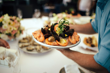 waiter serves shrimp