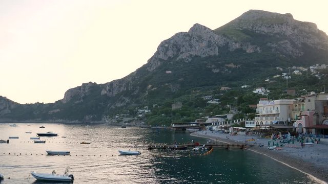 Nerano, Campania, italy - June 3 2018 : boats in  a beautifull beach of Marina del Cantone on Amalfi Coast at sunset.