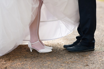 detail of brides and grooms feet against each other 