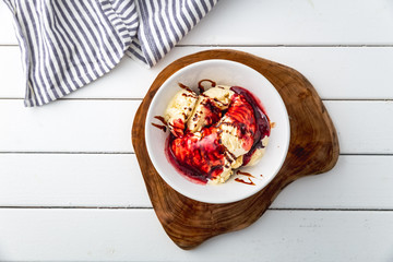 delicious vanilla ice cream with raspberry sauce