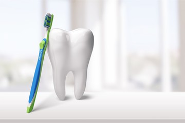 Big tooth and dentist mirror in dentist clinic on background