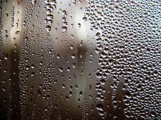 Drops of water on a cold glass.