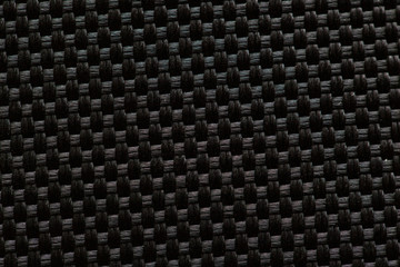 black surface of woven threads in macro, background, texture