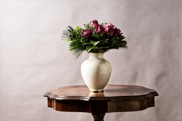 bouquet of flowers, on old coffee-table with old antique vase,