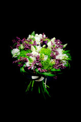 Beautiful bouquet with roses, carnations and ornithogalum or star of Bethlehem flowers isolated on a black background