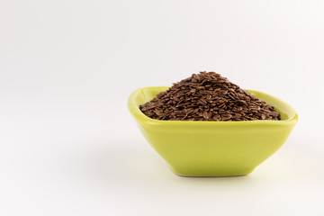 flax seeds in bowl on table background
