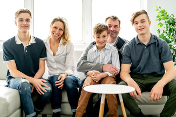 A Beautiful happy family sit on sofa at home