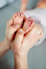 Baby feet in parent hands. Father and him Child. Happy Family concept.