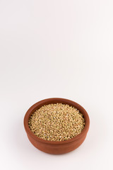 Natural fresh green buckwheat in bowl isolated on white background.