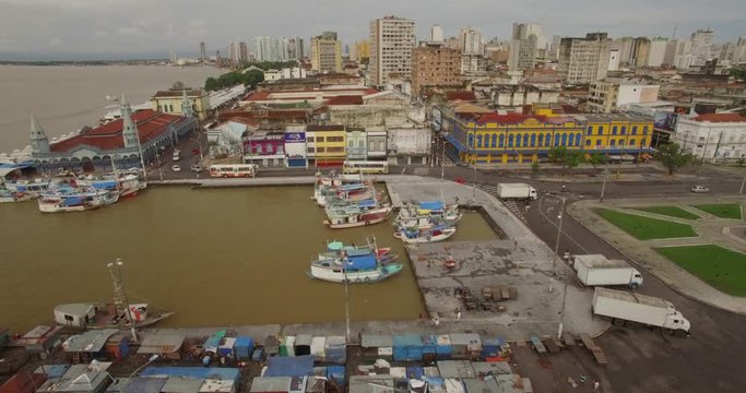 Sideways aerial of boats in dock and colonial facades in old port town of Belem do Para in the Brazilian Amazon