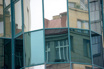 Close-up reflections in modern glass facade in Prague, Czech Republic.