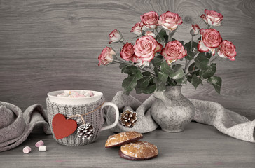 Valentines day still life with cup of hot chocolate with marshmallows, pink roses and scarf