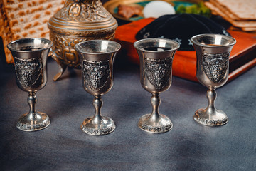 Red kosher wine four of matzah or matza Passover Haggadah on a vintage wood background