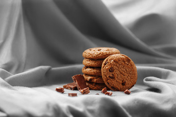 Oatmeal cookies with chocolate, on a background of gray fabric