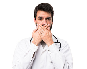 Young doctor covering his mouth on white background