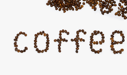 Coffee grains on a white background, the inscription coffee from the beans.