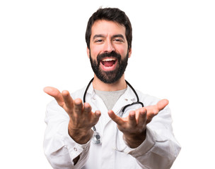 Young doctor presenting something on white background