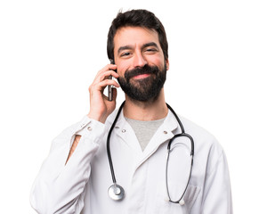 Young doctor talking to mobile on white background