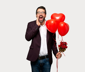 Man in valentine day shouting and announcing something over isolated grey background