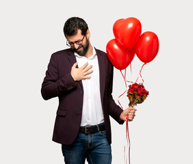 Man in valentine day having a pain in the heart over isolated grey background