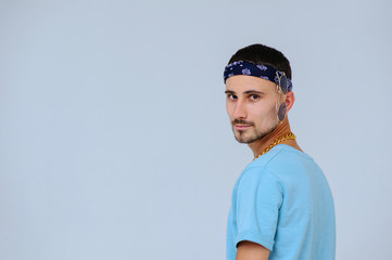 fashionable bright man with a bandage on his head in retro style manifestation of emotions of joy, gestures with hands space for text