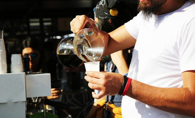 barista close up hands preparing delicious coffee, pouring coffee to mug, at coffeeshop restaurant in cafe preparation concept. can be used as a background