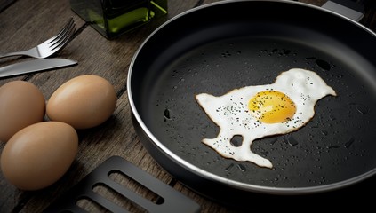 Kitchen composition, chick-shaped egg on skillet