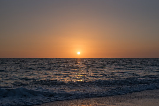 Calm dim sunset over ocean © Katherine