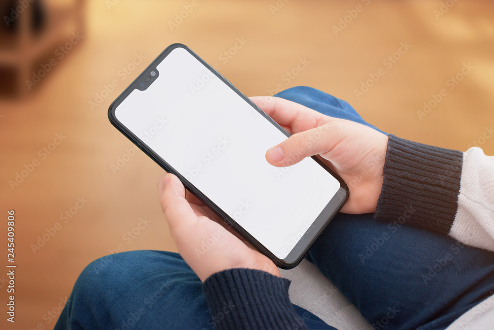 Aufkleber modern smart phone with round edges and screen tooth in boy hands. isolated screen for mockup, app p