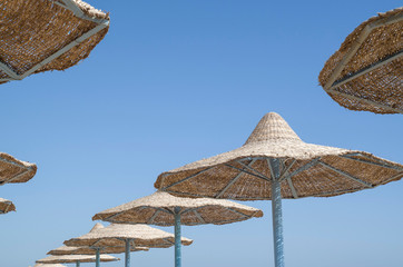 Many beach umbrella from wicker in the sky, Egypt