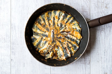 Fresh Fried Sardines / Anchovy Hamsi Tava in Pan on Wooden Surface.