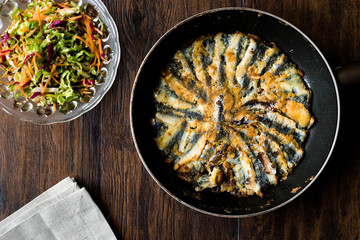 Fresh Fried Sardines / Anchovy Hamsi Tava in Pan on Wooden Surface.