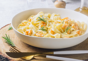 Italian pasta tagliatelle in a creamy sauce with shrimp