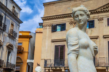 Feminine white stone statue in a Palermo square